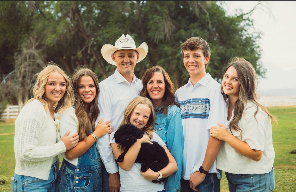 Adam Hahn with his wife and five children on a ranch outside Cedar City, Utah.